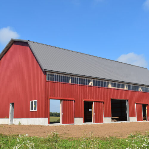 New,Red,Barn,Constructed,On,A,Farm,In,Summer,With